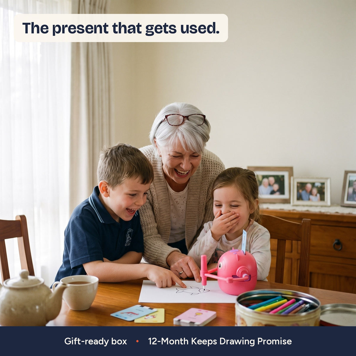 Nan and two grandchildren watching The Scribble Bot at her dining table